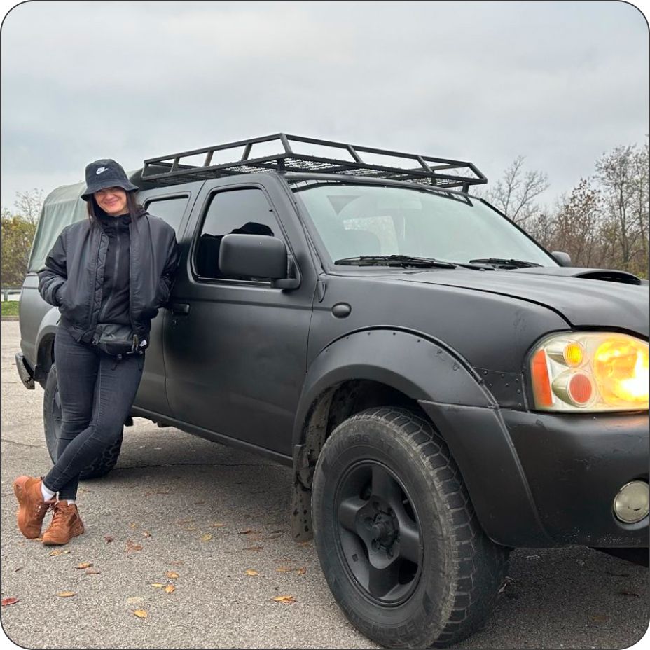Volunteer next to an off-road vehicle